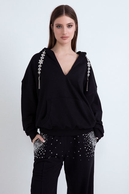 Tuta sportiva nera da donna con felpa con cappuccio e pantaloni a palazzo con strass.