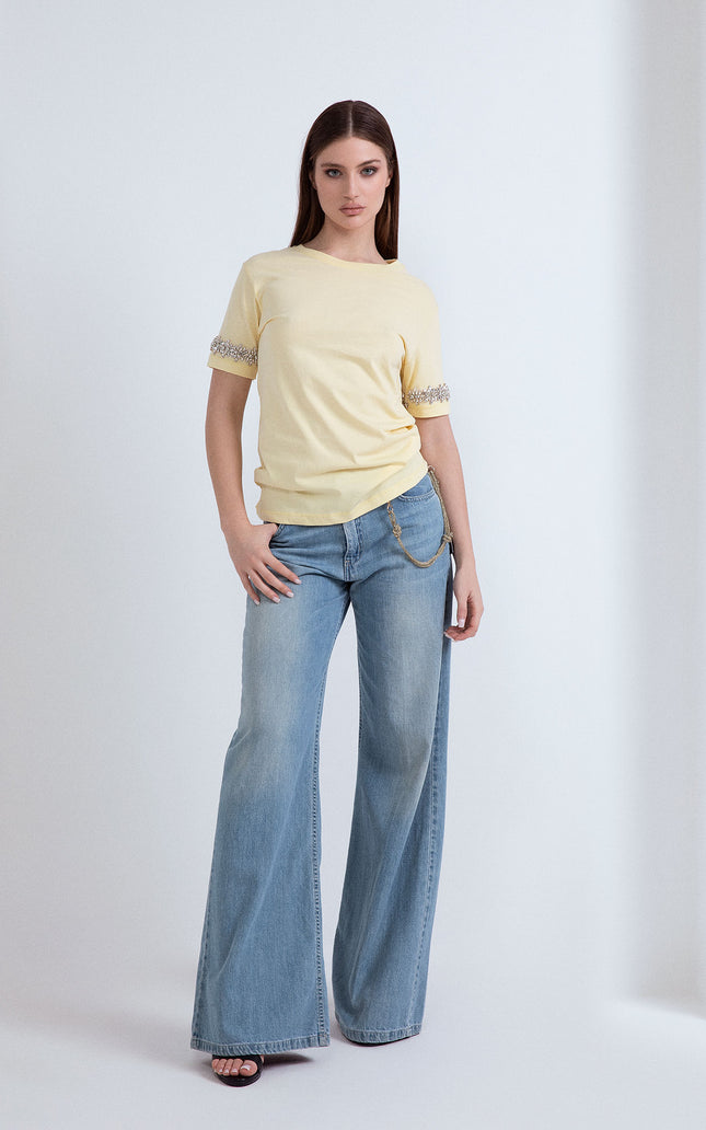T-shirt gialla a girocollo in cotone con applicazione di pietre preziose sulle maniche corte.