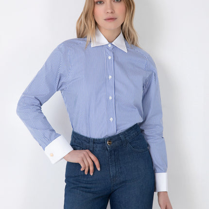 Woman wearing blue striped long-sleeve shirt with white collar and cuffs and blue jeans