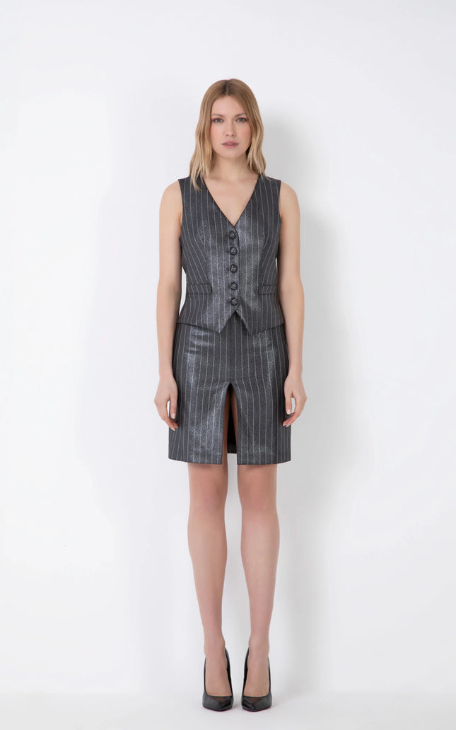 Woman wearing metallic pinstripe gilet vest and matching skirt with front slit