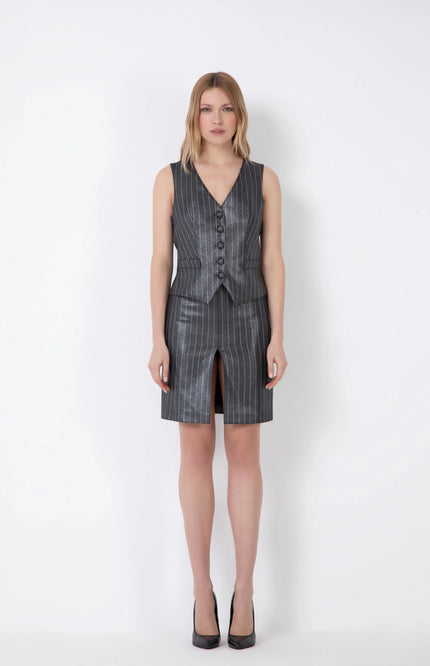 Woman wearing metallic pinstripe gilet vest and matching skirt with front slit