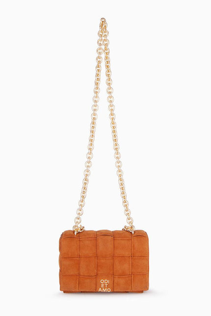 Brown quilted suede shoulder bag with gold chain strap on white background