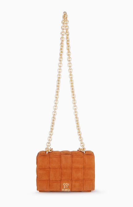 Brown quilted suede shoulder bag with gold chain strap on white background