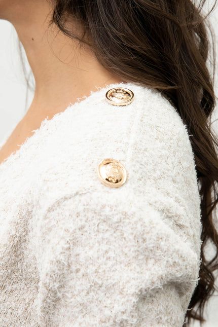 White textured sweater with gold decorative buttons on shoulder, women's fashion detail