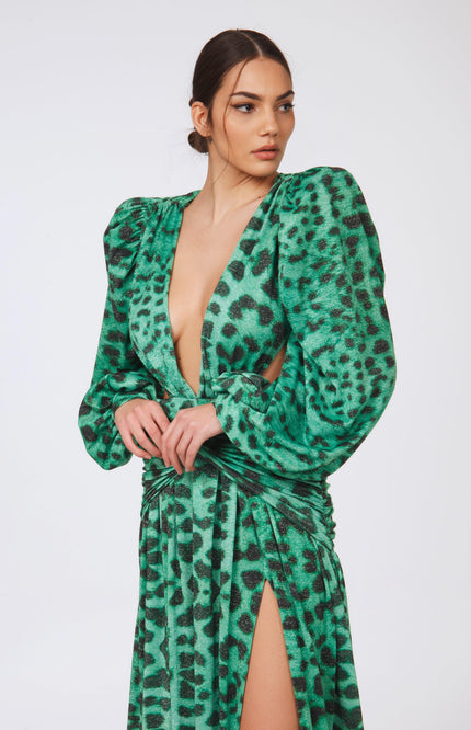 Woman wearing bold green leopard print dress with puff sleeves, deep V-neck, and thigh-high slit